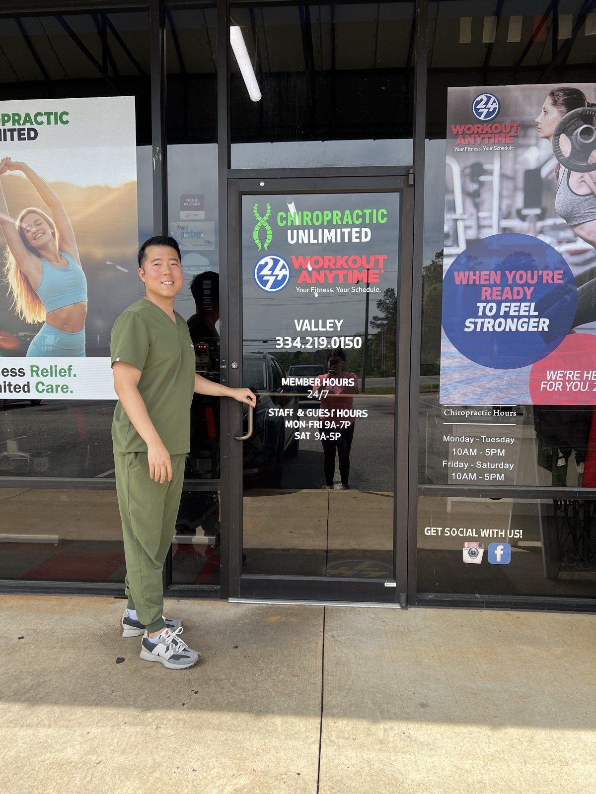Dr. Jason Bang at the entrance of Chiropractic Unlimited inside Workout Anytime, Valley AL